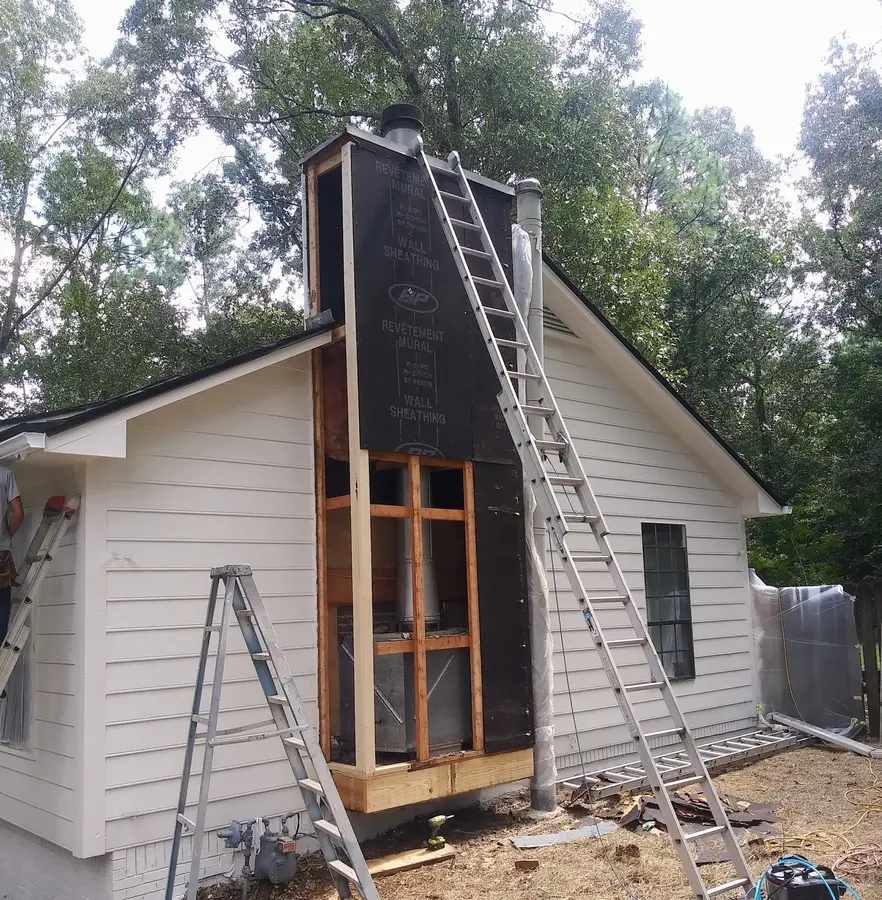 Residential chimney exterior repair in progress before painting