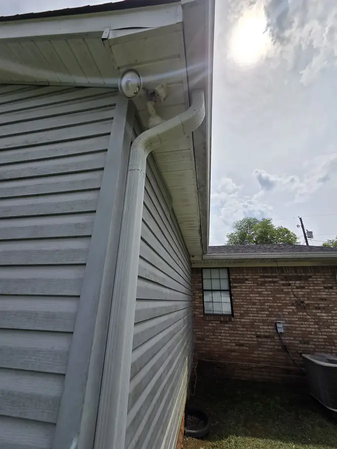 Freshly painted exterior siding and white trim on a home