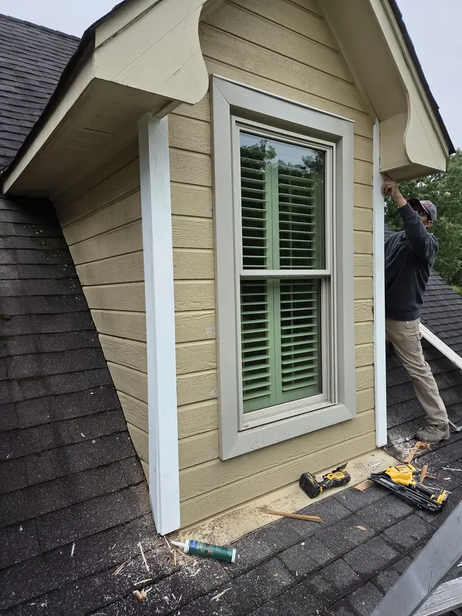 Exterior dormer window trim repair in progress