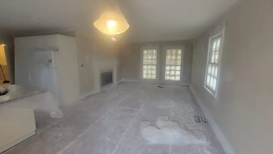Finished interior living room painting with light walls and white trim
