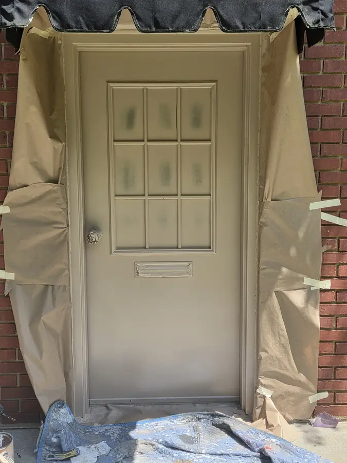 Front entry door masked and prepared for exterior painting