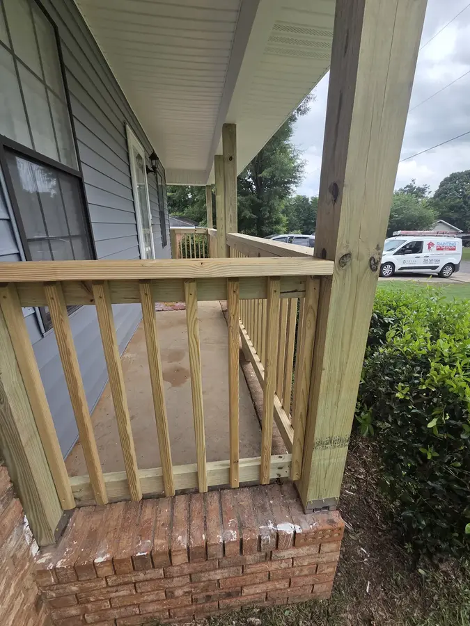 New wood porch railing repair fitted to an existing brick porch