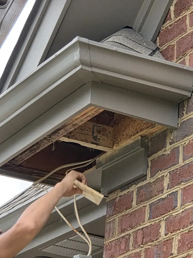 Damaged soffit and fascia opened for repair before painting