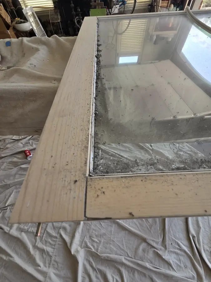 Wood window frame repaired and primed during restoration